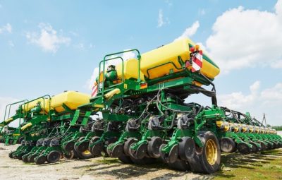 close-up-seeder-attached-tractor-field_146671-19082